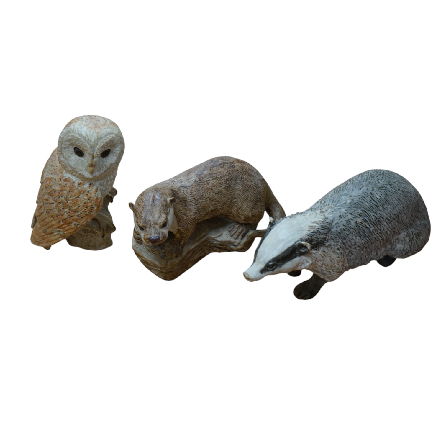 Audrey Carter, three studio pottery animal models, an owl, otter and badger, 37cm. Condition - good